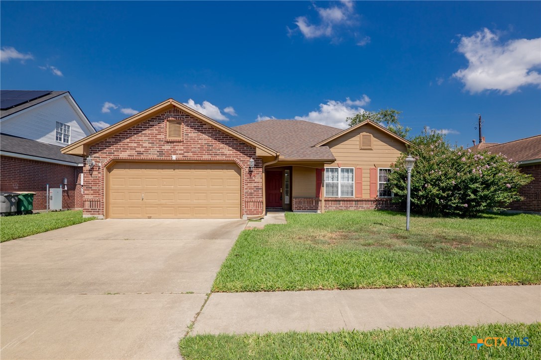409 Newhaven Street Victoria, TX 77904 - Photo 23 of 28 a front view of a house with a yard and garage