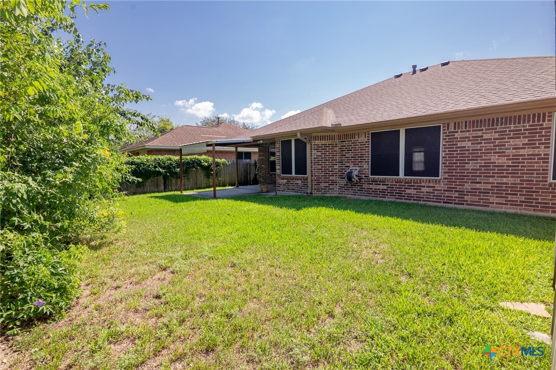409 Newhaven Street Victoria, TX 77904 - Photo 25 of 28 a backyard of a house with yard and outdoor seating