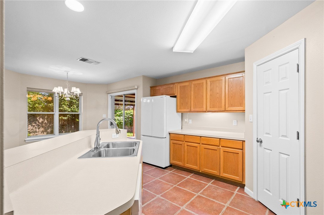 409 Newhaven Street Victoria, TX 77904 - Photo 7 of 28 a kitchen with a sink and a refrigerator