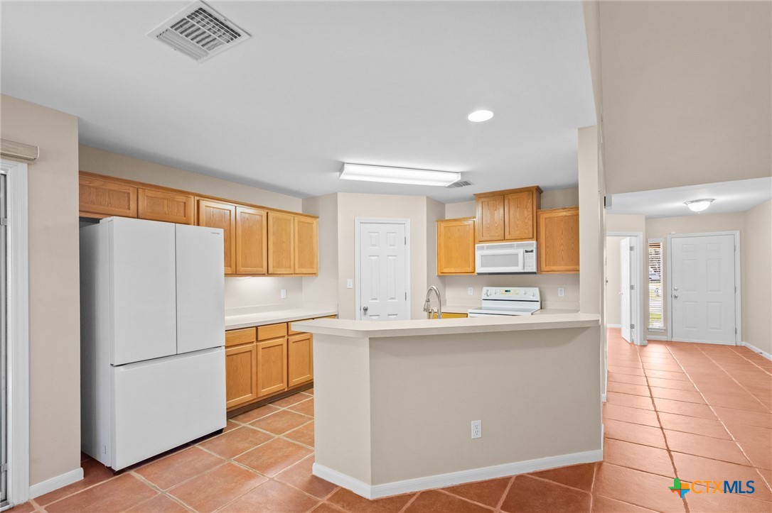 409 Newhaven Street Victoria, TX 77904 - Photo 9 of 28 a kitchen with a sink a refrigerator and cabinets
