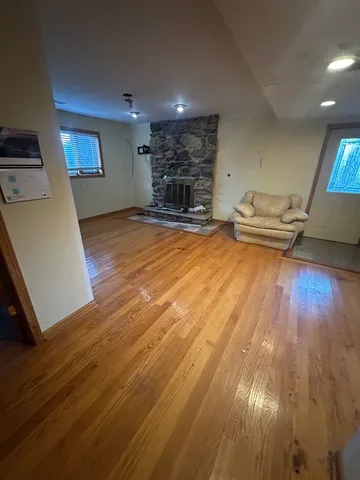 a view of a livingroom with furniture wooden floor and staircase