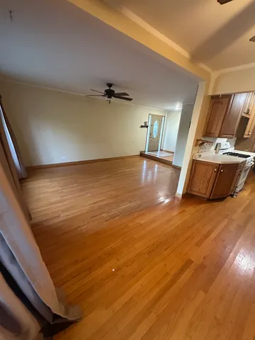 a view of a room with wooden floor