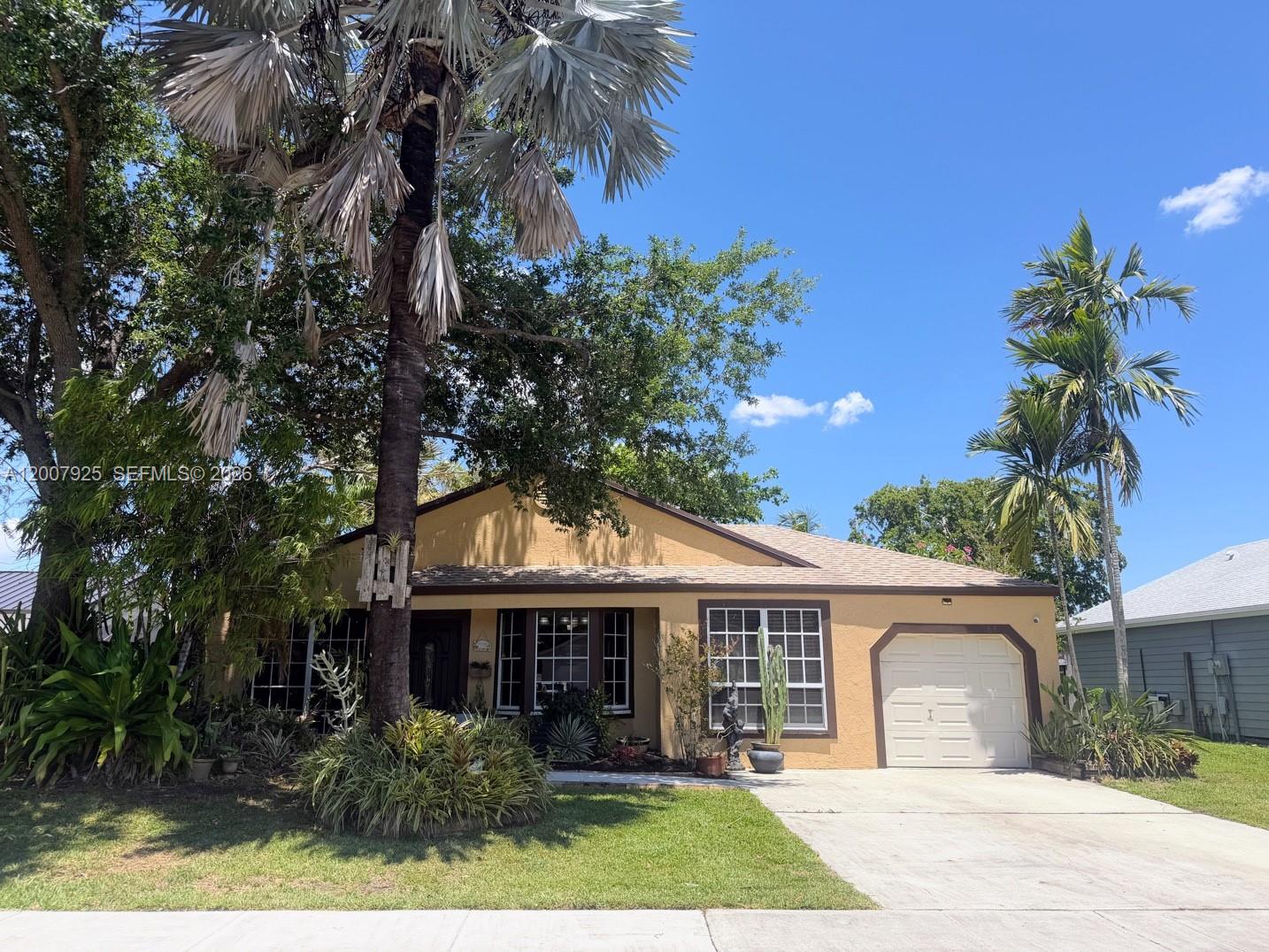13541 Southwest 10th Place Davie, FL 33325 - Photo 1 of 20 a front view of a house with a garden