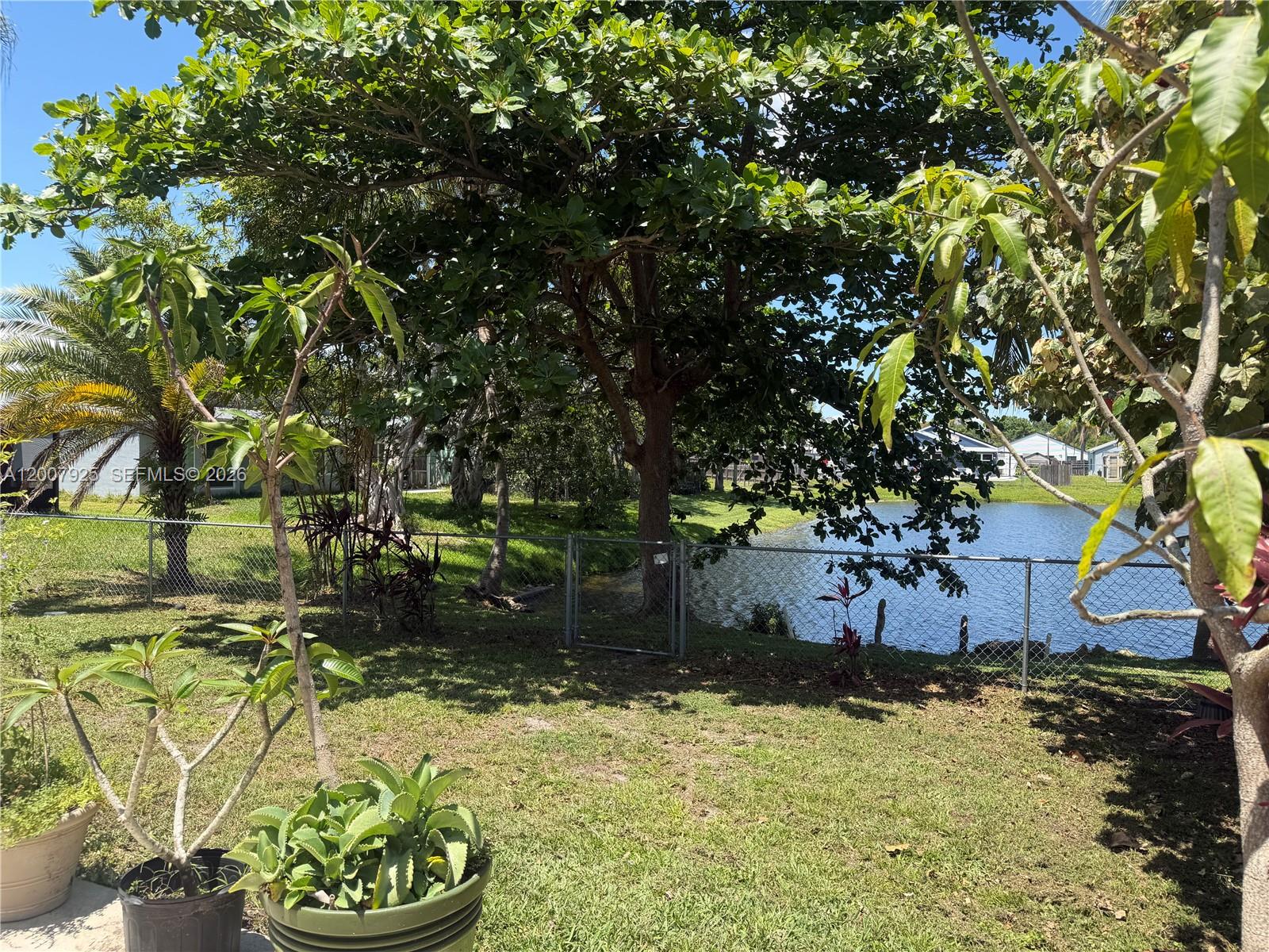 13541 Southwest 10th Place Davie, FL 33325 - Photo 17 of 20 a view of a garden with a bench
