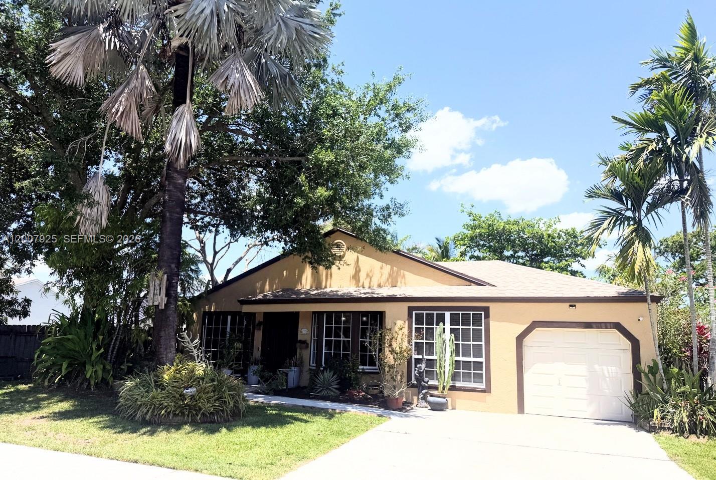 13541 Southwest 10th Place Davie, FL 33325 - Photo 20 of 20 a front view of a house with garden