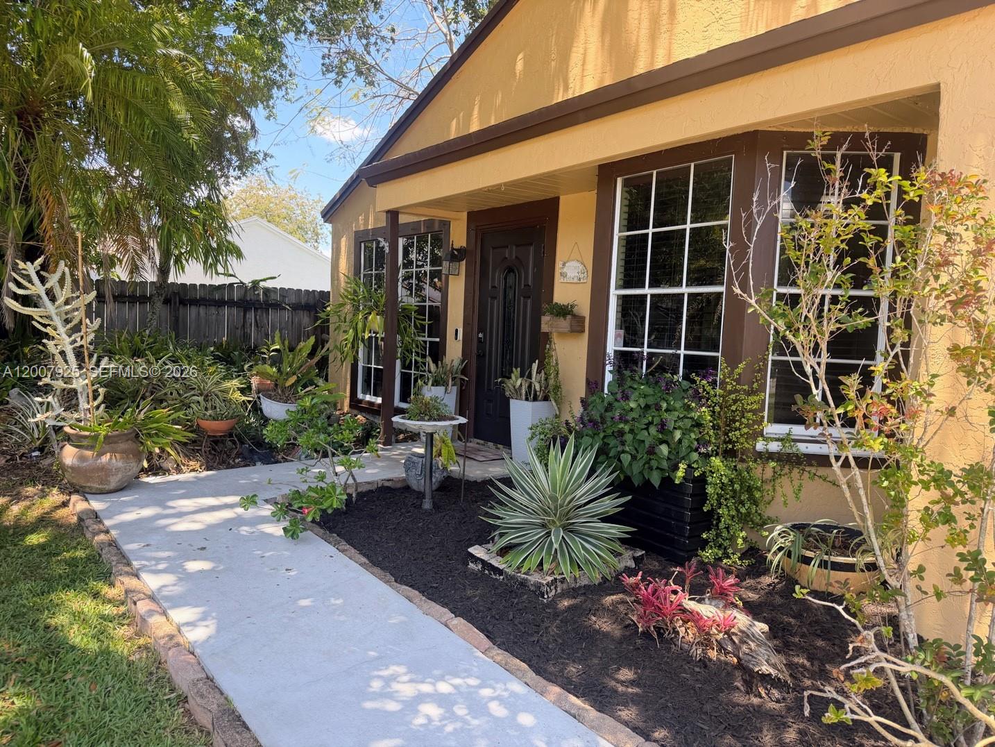 13541 Southwest 10th Place Davie, FL 33325 - Photo 2 of 20 a view of a house with potted plants