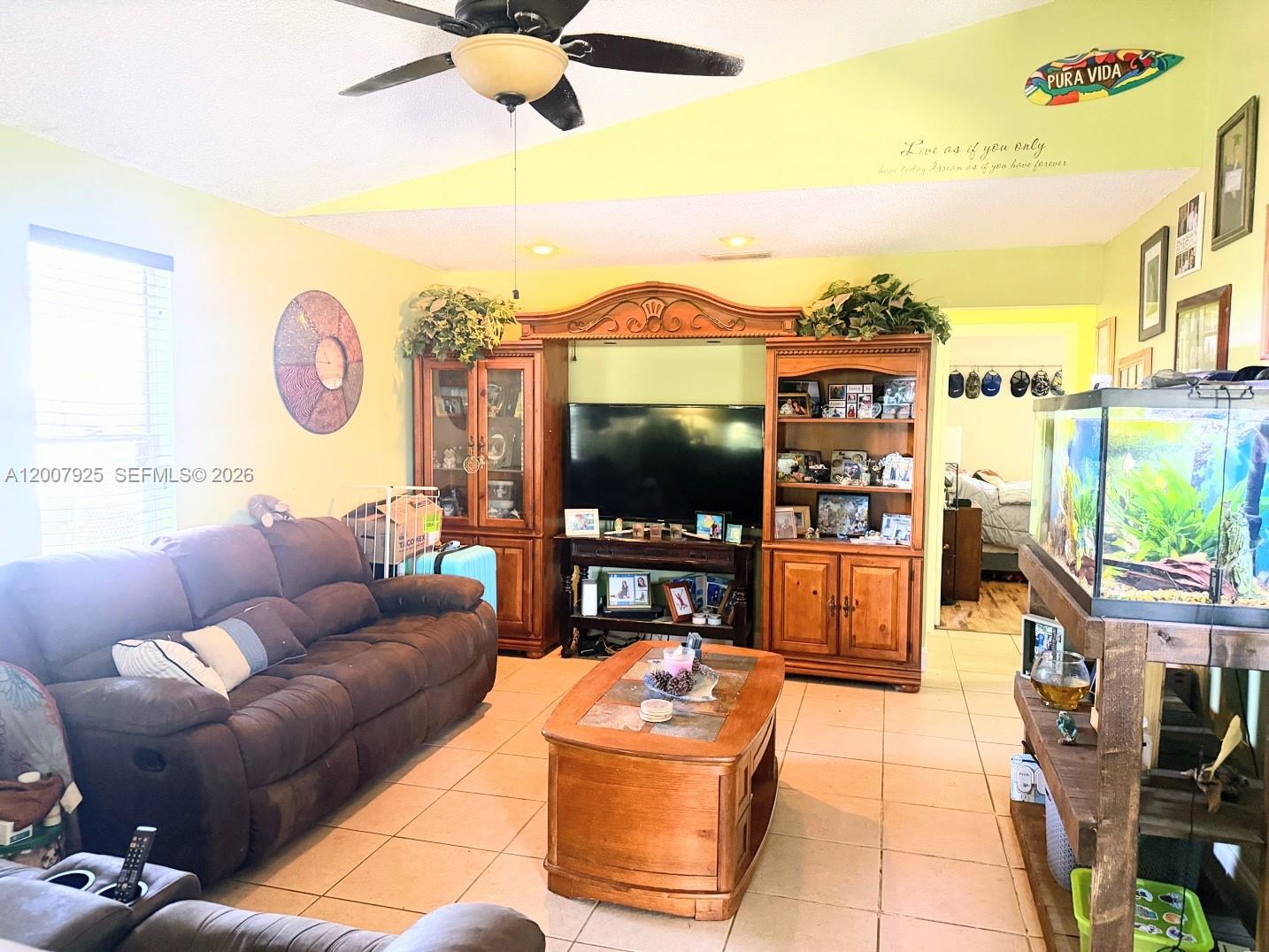 13541 Southwest 10th Place Davie, FL 33325 - Photo 3 of 20 a living room with furniture and a flat screen tv
