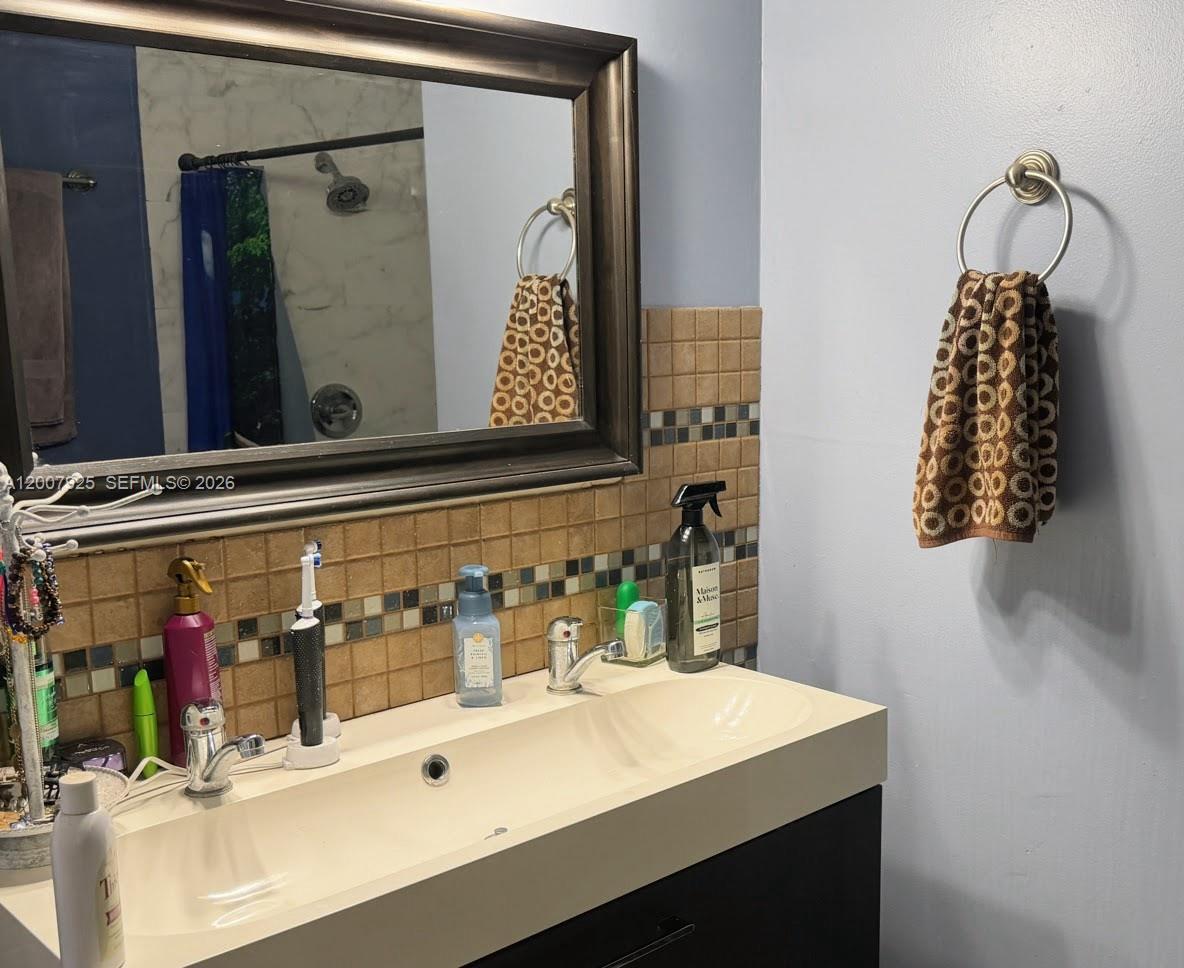 13541 Southwest 10th Place Davie, FL 33325 - Photo 10 of 20 a bathroom with a sink and a mirror
