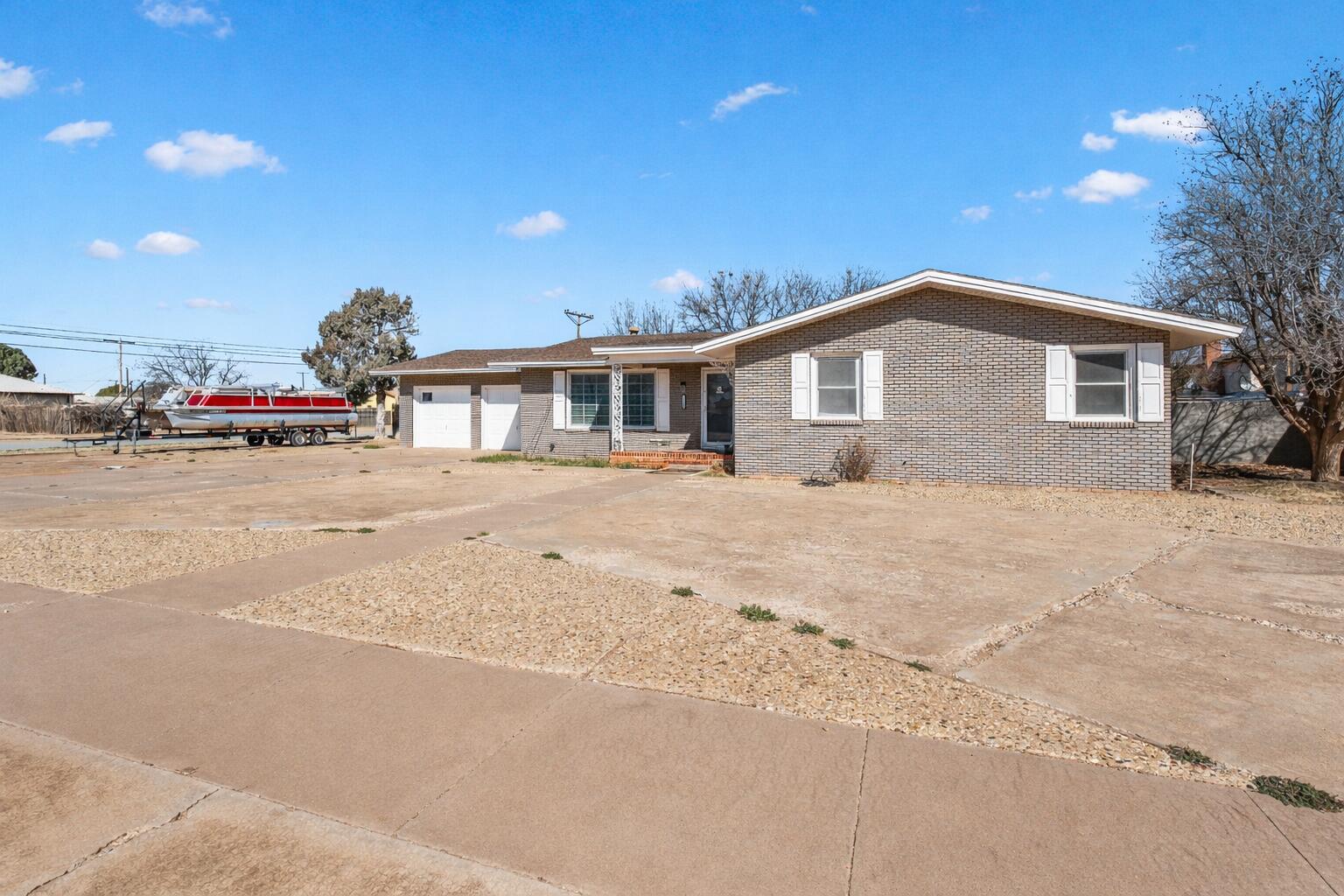 1201 8th Street Shallowater, TX 79363 - Photo 2 of 20 a front view of a house with a yard and garage