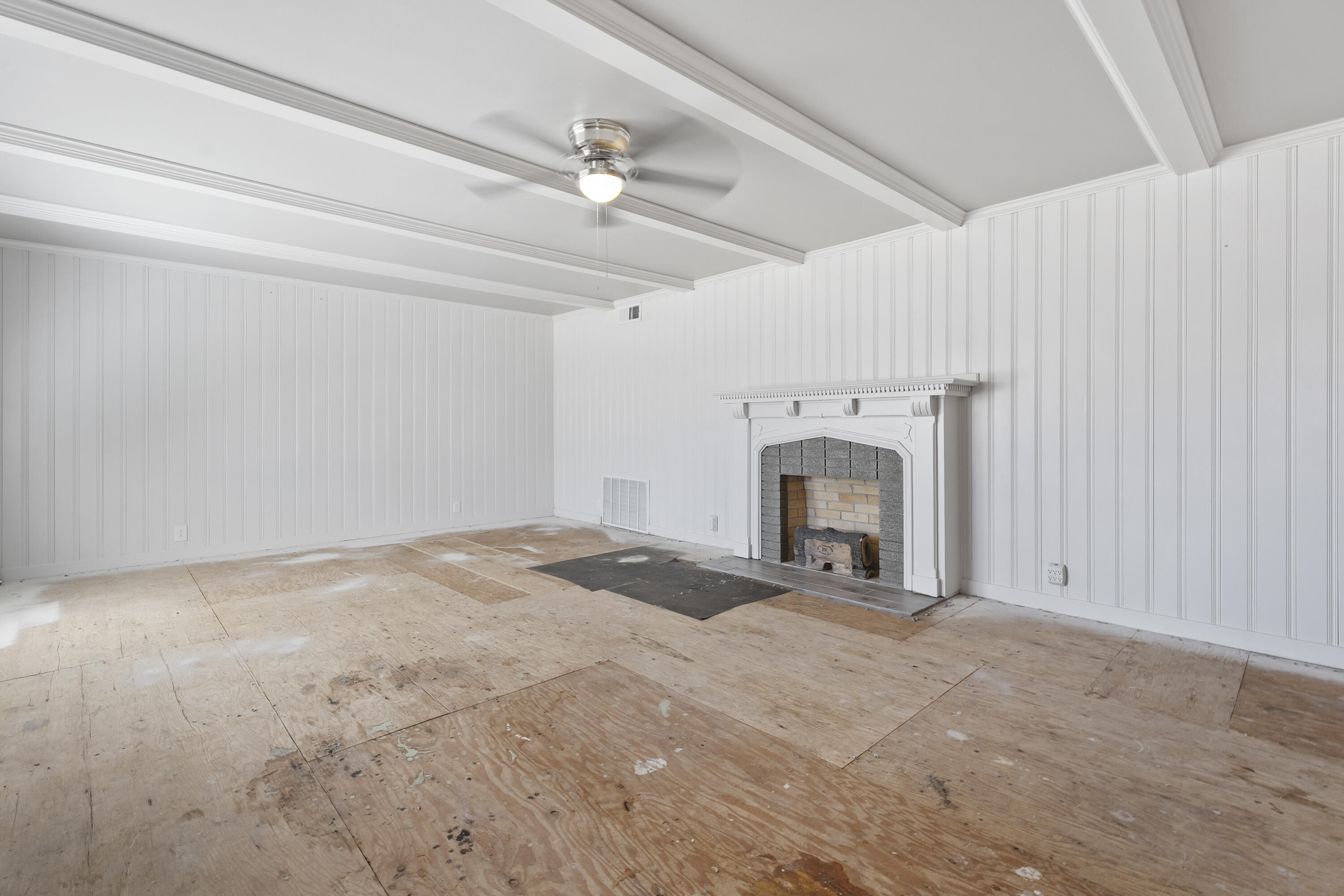 1201 8th Street Shallowater, TX 79363 - Photo 4 of 20 a view of empty room with a fireplace and ceiling fan