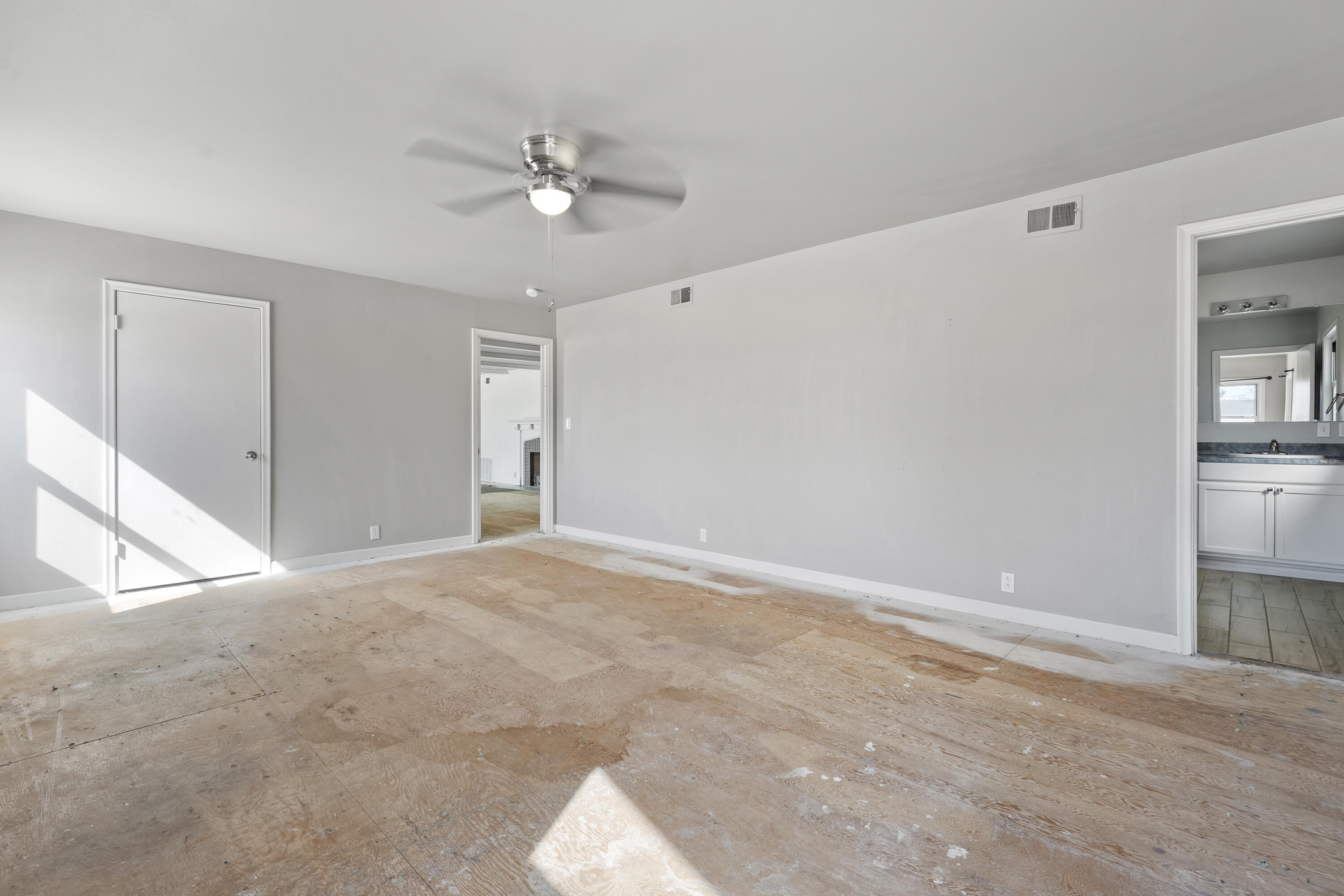 1201 8th Street Shallowater, TX 79363 - Photo 5 of 20 a view of an empty room with a chandelier fan