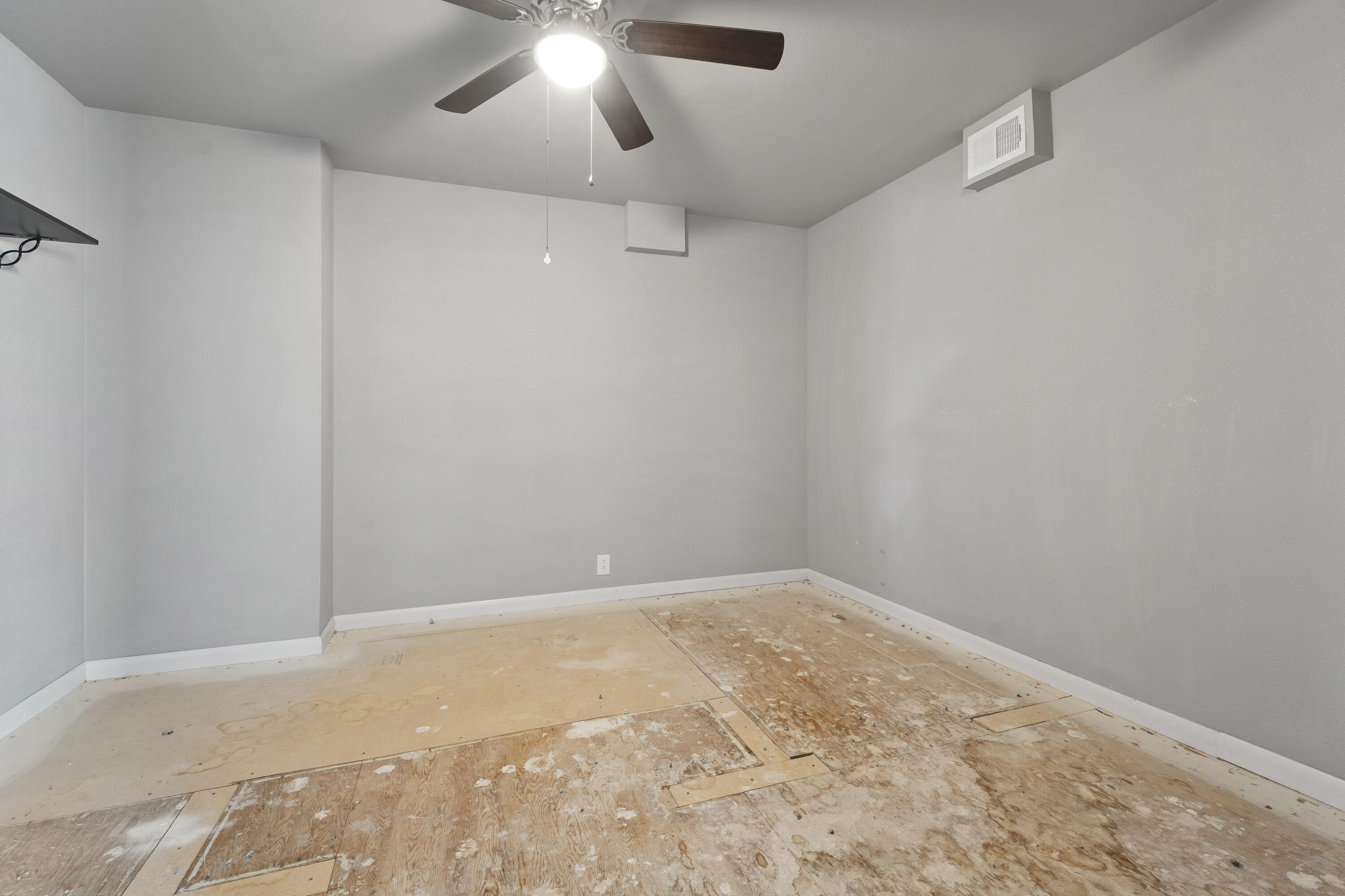 1201 8th Street Shallowater, TX 79363 - Photo 7 of 20 an empty room with a chandelier fan