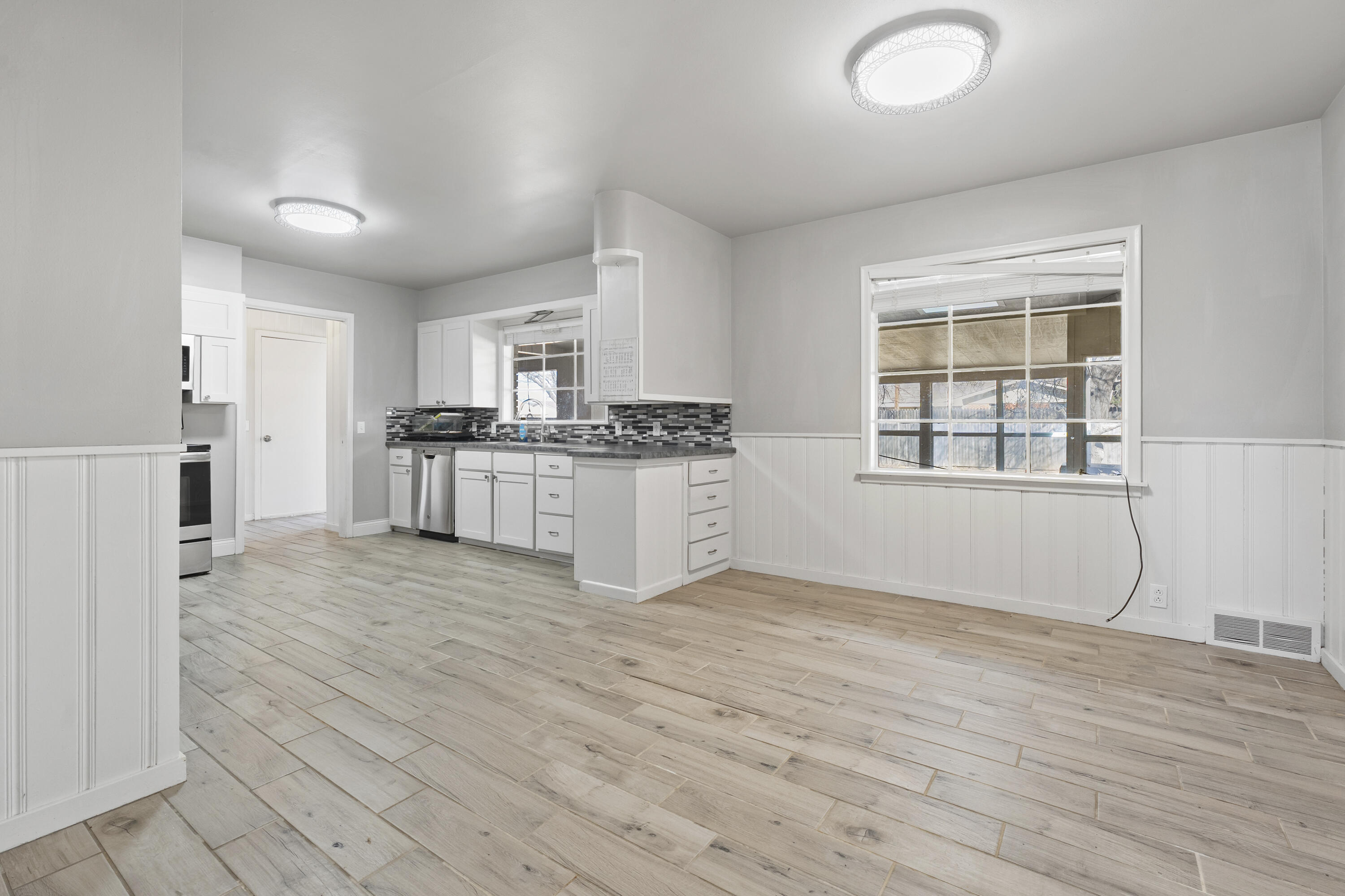 1201 8th Street Shallowater, TX 79363 - Photo 8 of 20 a kitchen with granite countertop a stove and a refrigerator