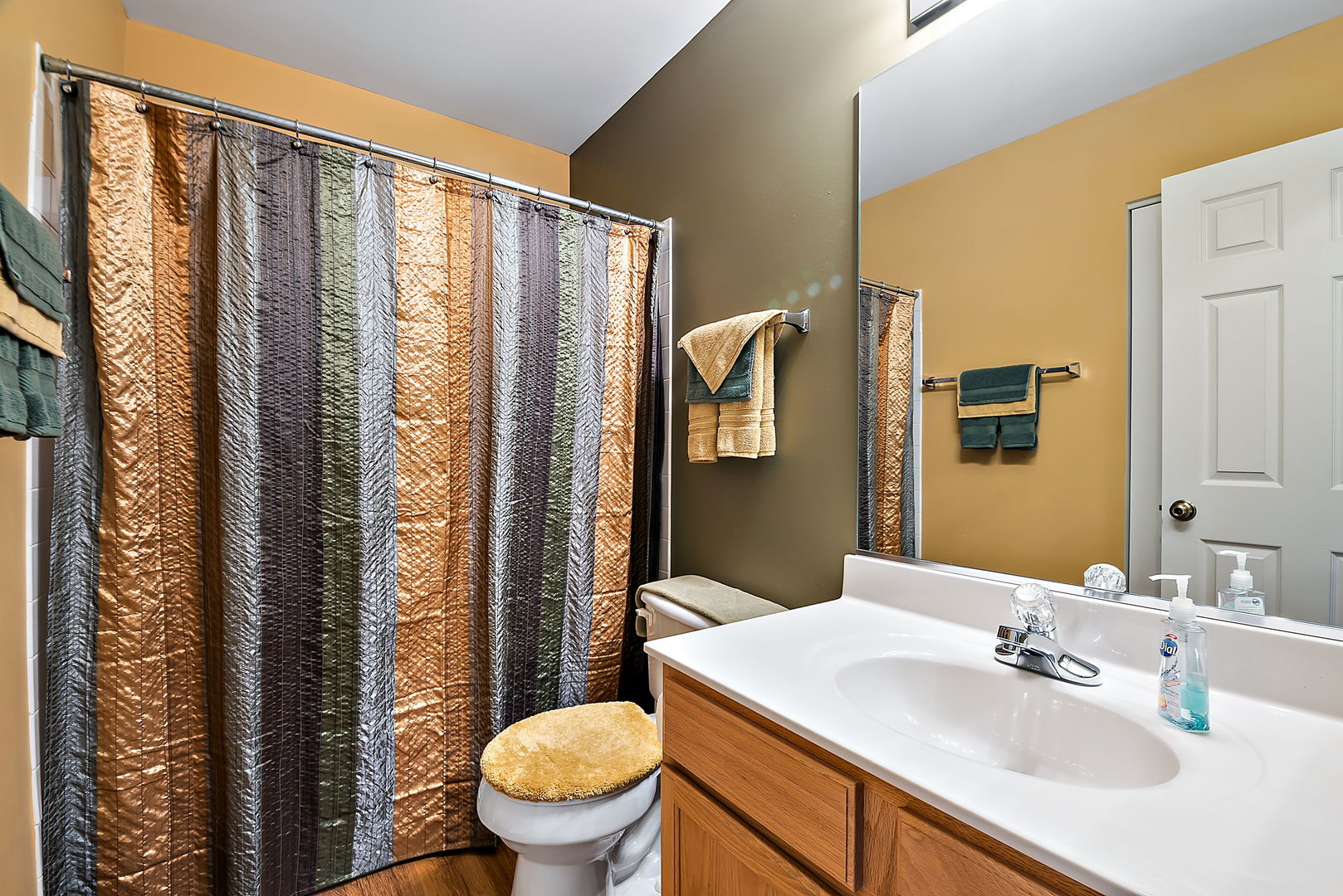 2926 Rutland Circle Naperville, IL 60564 - Photo 7 of 9 a bathroom with a sink a toilet a mirror and shower