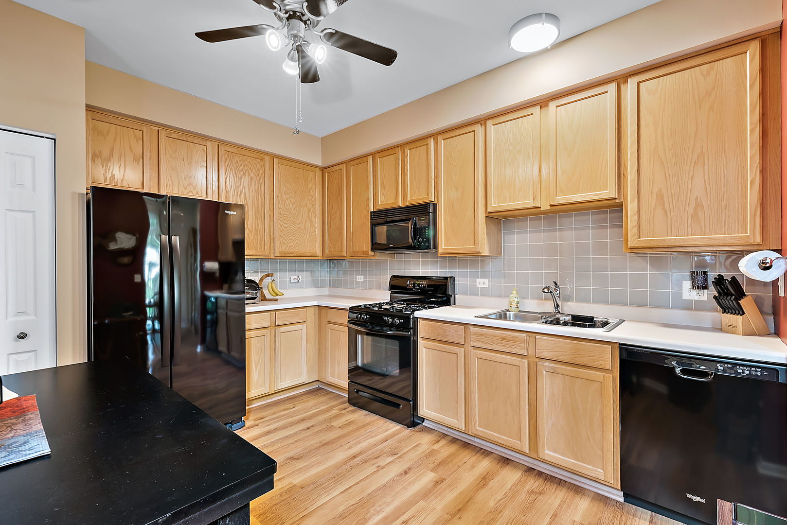 2926 Rutland Circle Naperville, IL 60564 - Photo 3 of 9 a kitchen with a sink stainless steel appliances and cabinets