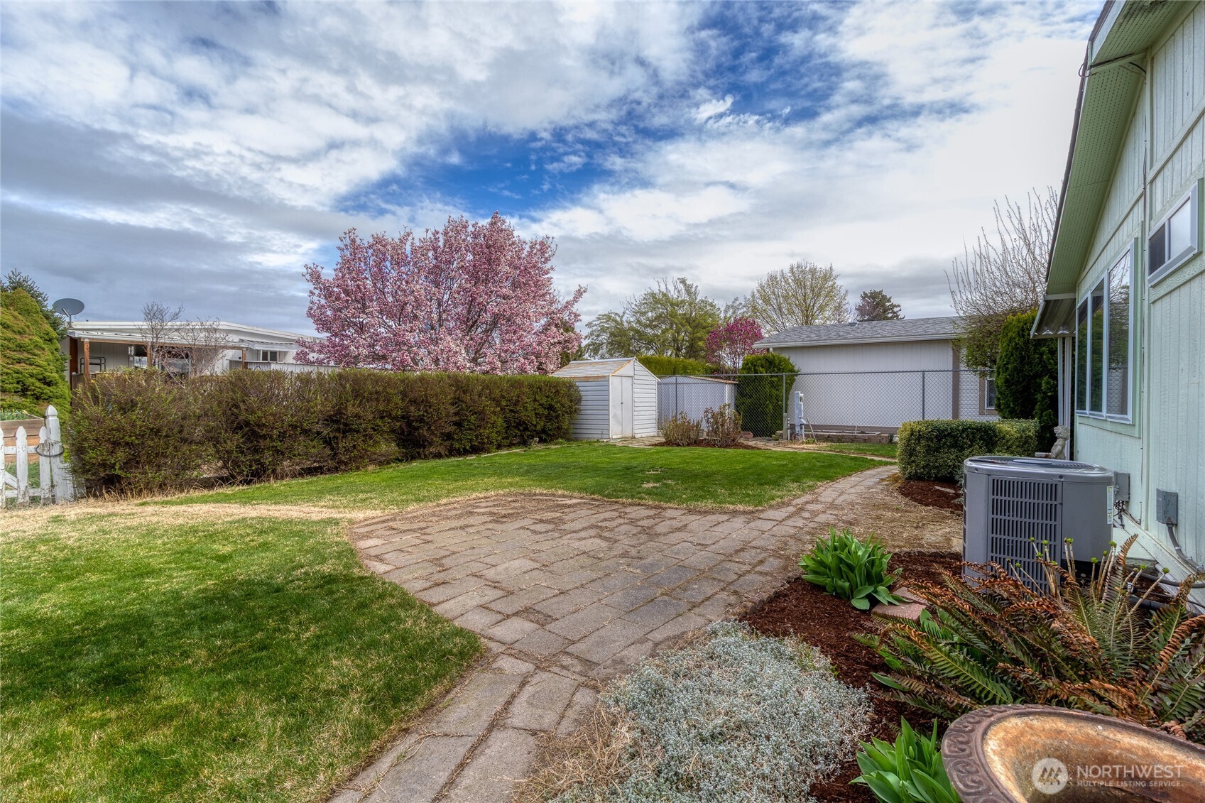 1312 Rancho Villa Walla Walla, WA 99362 - Photo 20 of 22 a view of a yard with plants and a large tree