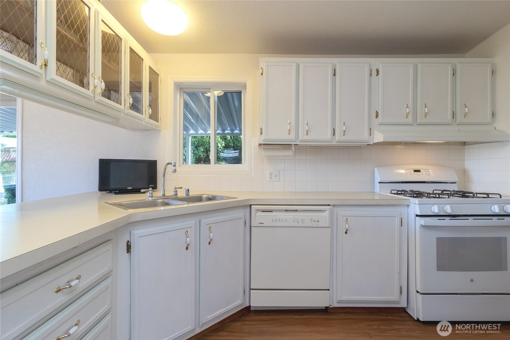 1312 Rancho Villa Walla Walla, WA 99362 - Photo 6 of 22 a kitchen with white cabinets and sink