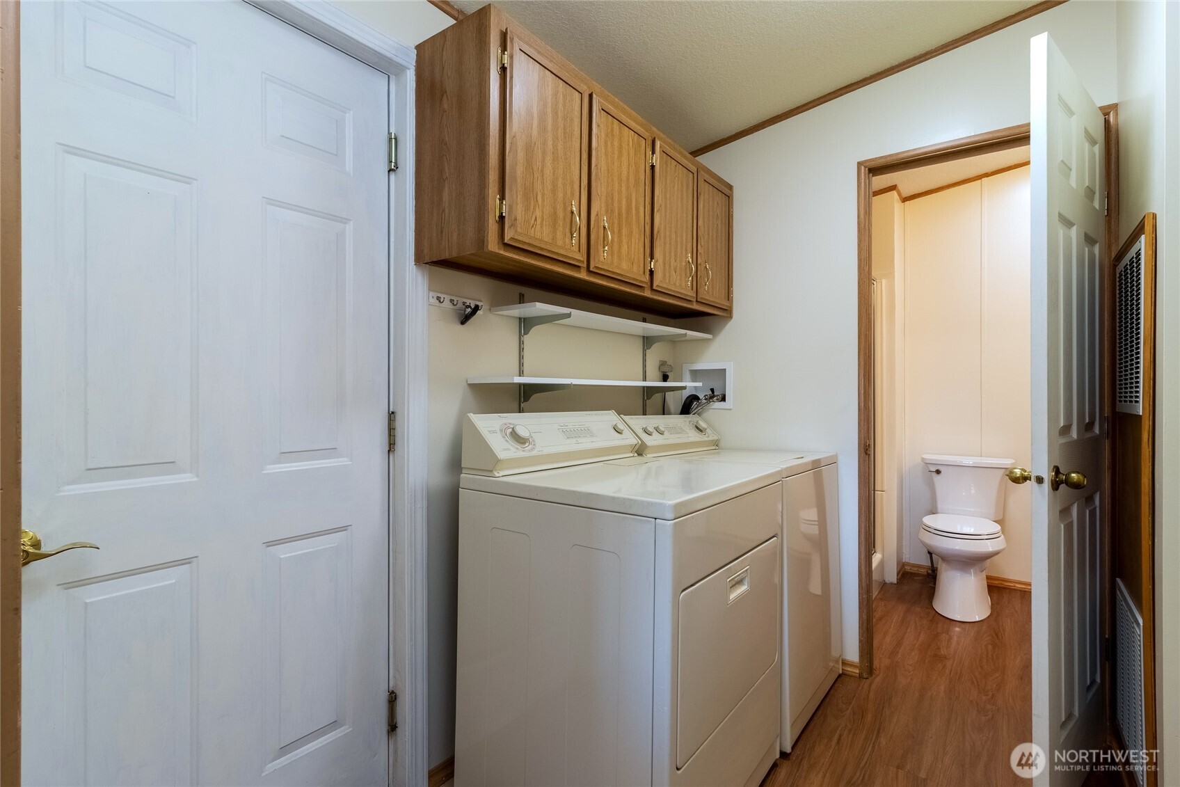 1312 Rancho Villa Walla Walla, WA 99362 - Photo 8 of 22 a utility room with a sink a toilet and a mirror