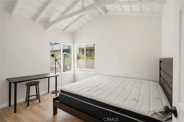 a bed sitting in a bedroom next to a window