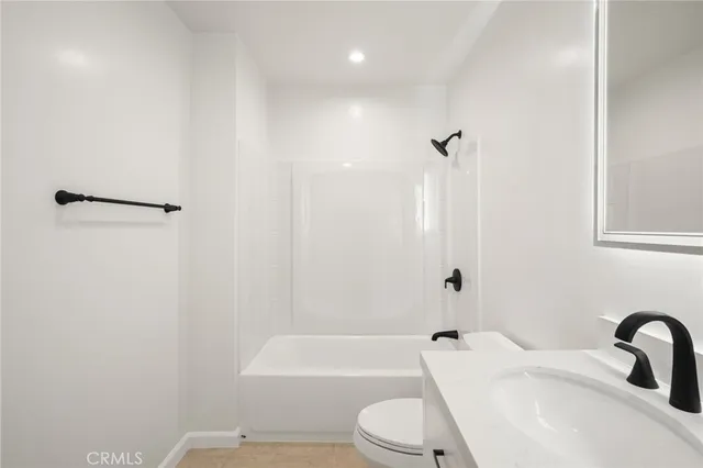 a bathroom with a toilet a sink and bathtub