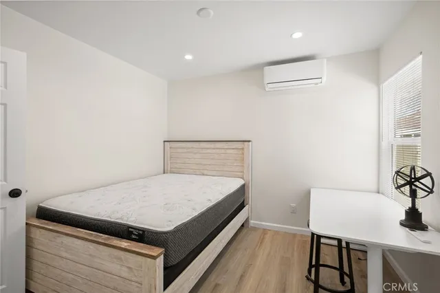 a bedroom with a bed and a table in it