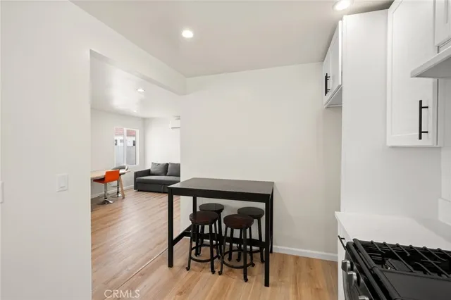 a view of a room with furniture and wooden floor