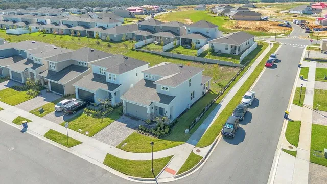 an aerial view of residential houses with swimming pool