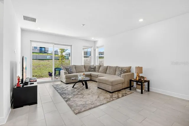 a living room with furniture and a large window