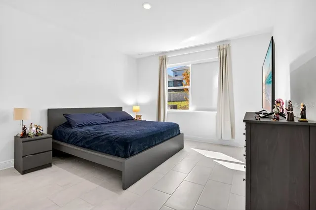 a bedroom with a bed and a dresser