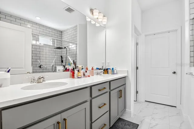 a bathroom with a double vanity sink and a mirror