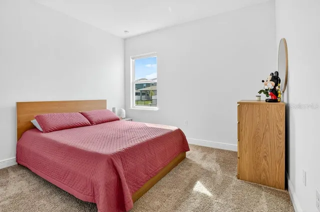 a bedroom with a bed and a dresser