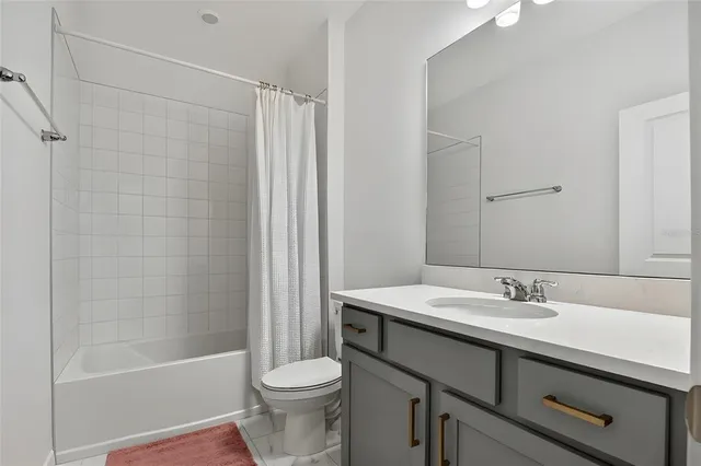 a bathroom with a sink a toilet and a bathtub