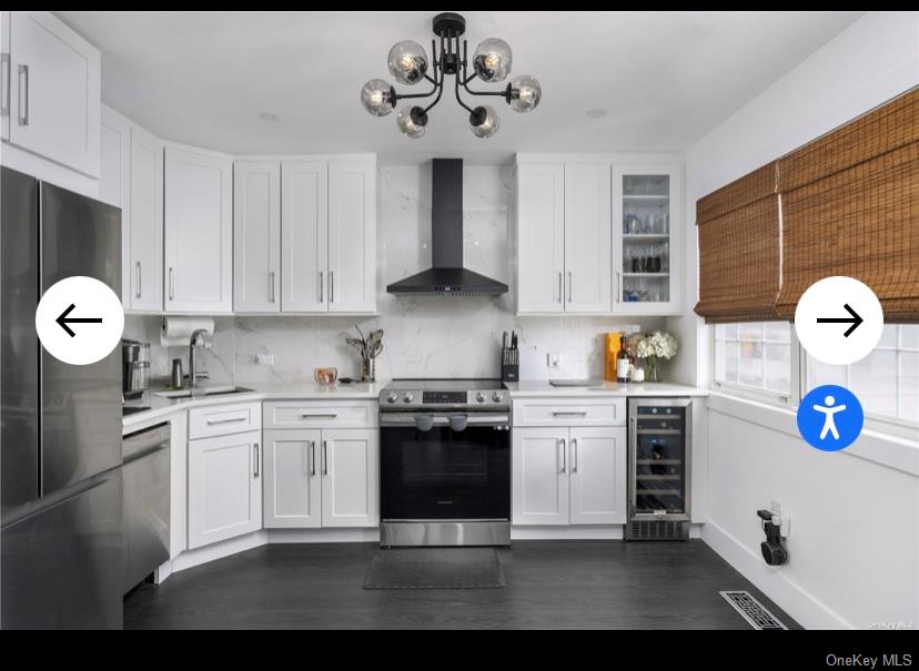 40 Canoe Place Road, Unit 3 Hampton Bays, NY 11946 - Photo 1 of 4 a kitchen with stainless steel appliances granite countertop a stove and cabinets