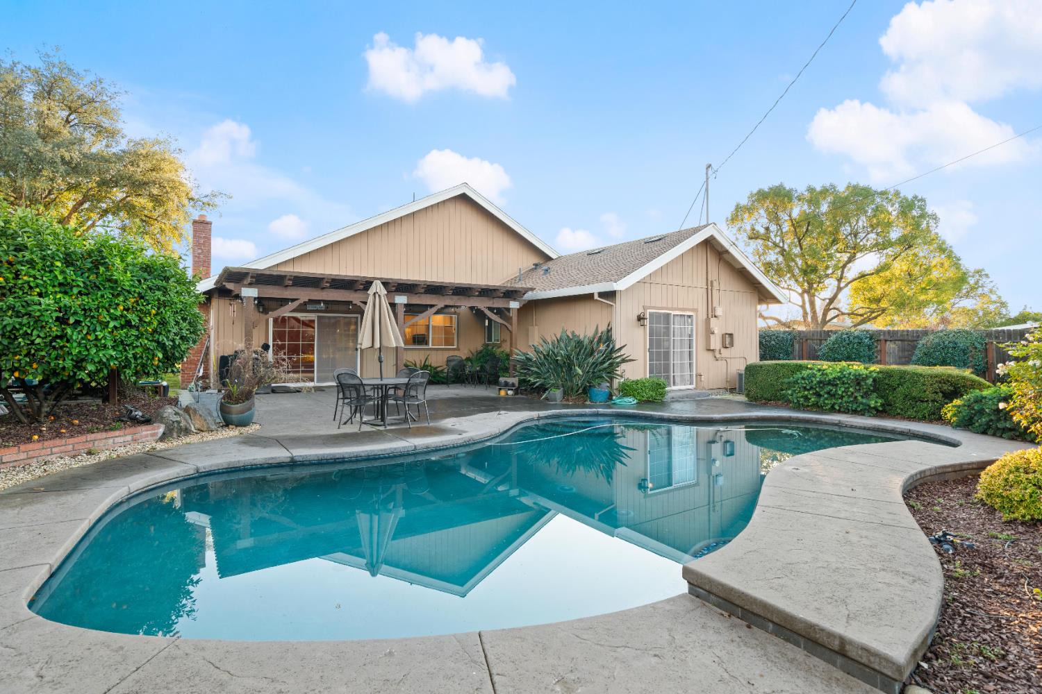 5001 Boyd Drive Carmichael, CA 95608 - Photo 1 of 49 a view of a house with sitting area and swimming pool