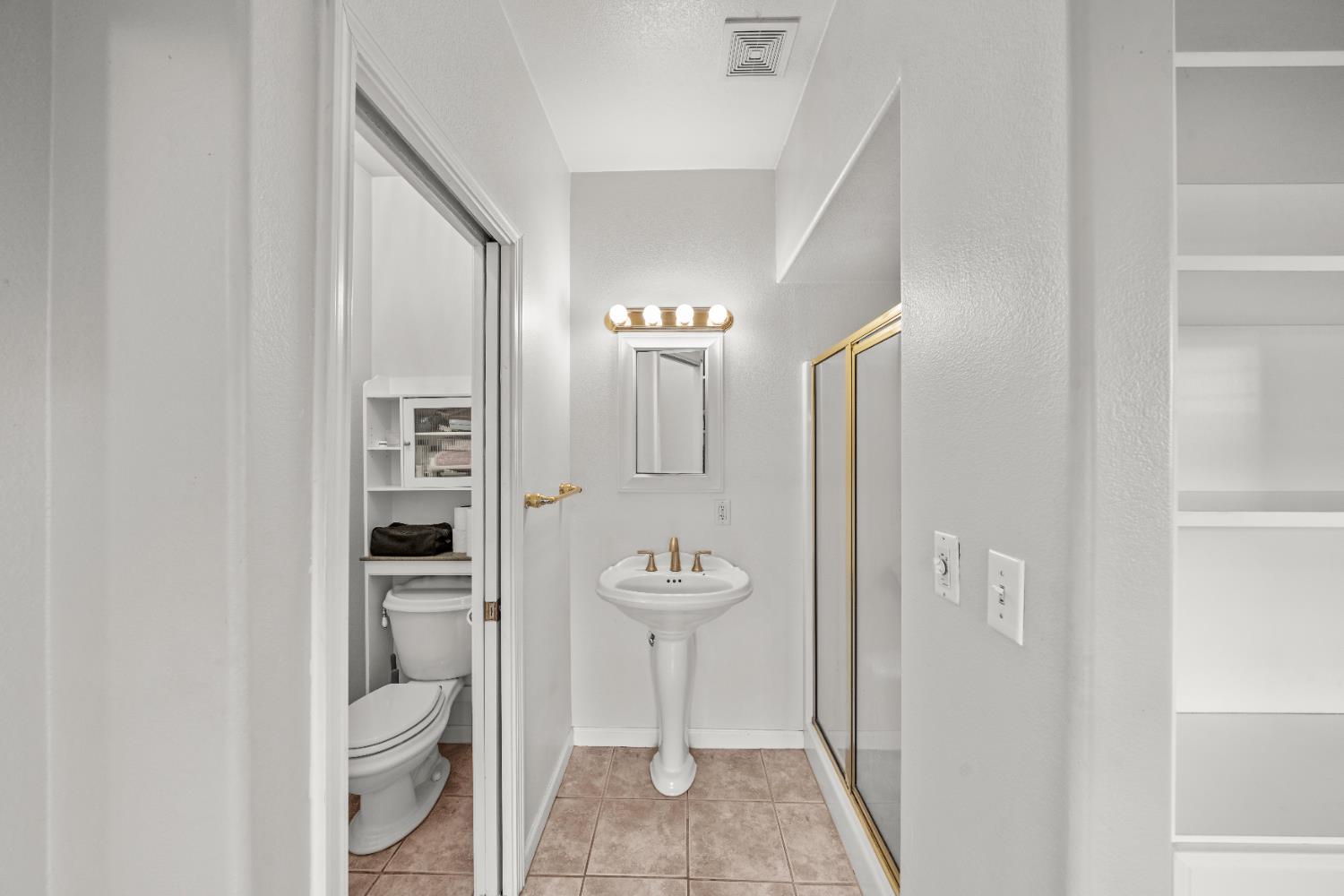 5001 Boyd Drive Carmichael, CA 95608 - Photo 14 of 49 a bathroom with a toilet a sink and mirror