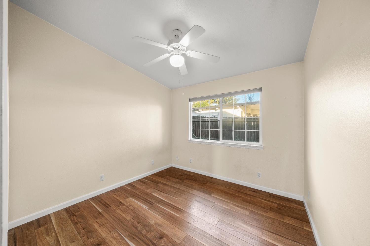5001 Boyd Drive Carmichael, CA 95608 - Photo 15 of 49 a view of an empty room with wooden floor and a window