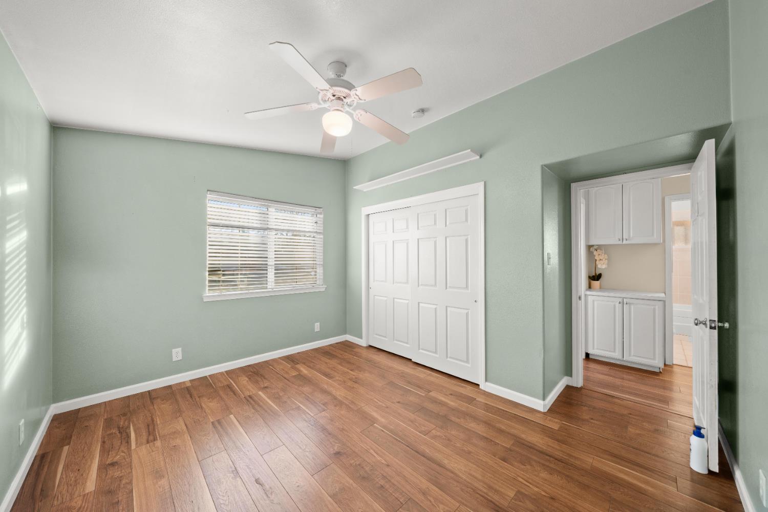 5001 Boyd Drive Carmichael, CA 95608 - Photo 18 of 49 an empty room with wooden floor fan and windows