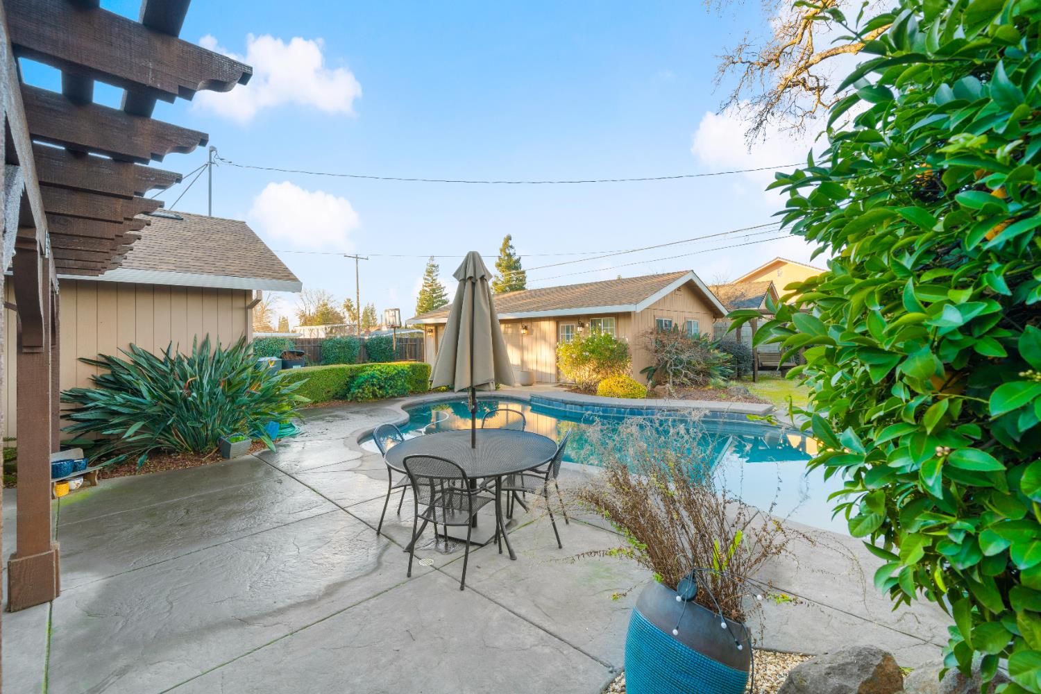 5001 Boyd Drive Carmichael, CA 95608 - Photo 25 of 49 a patio with table and chairs and potted plants