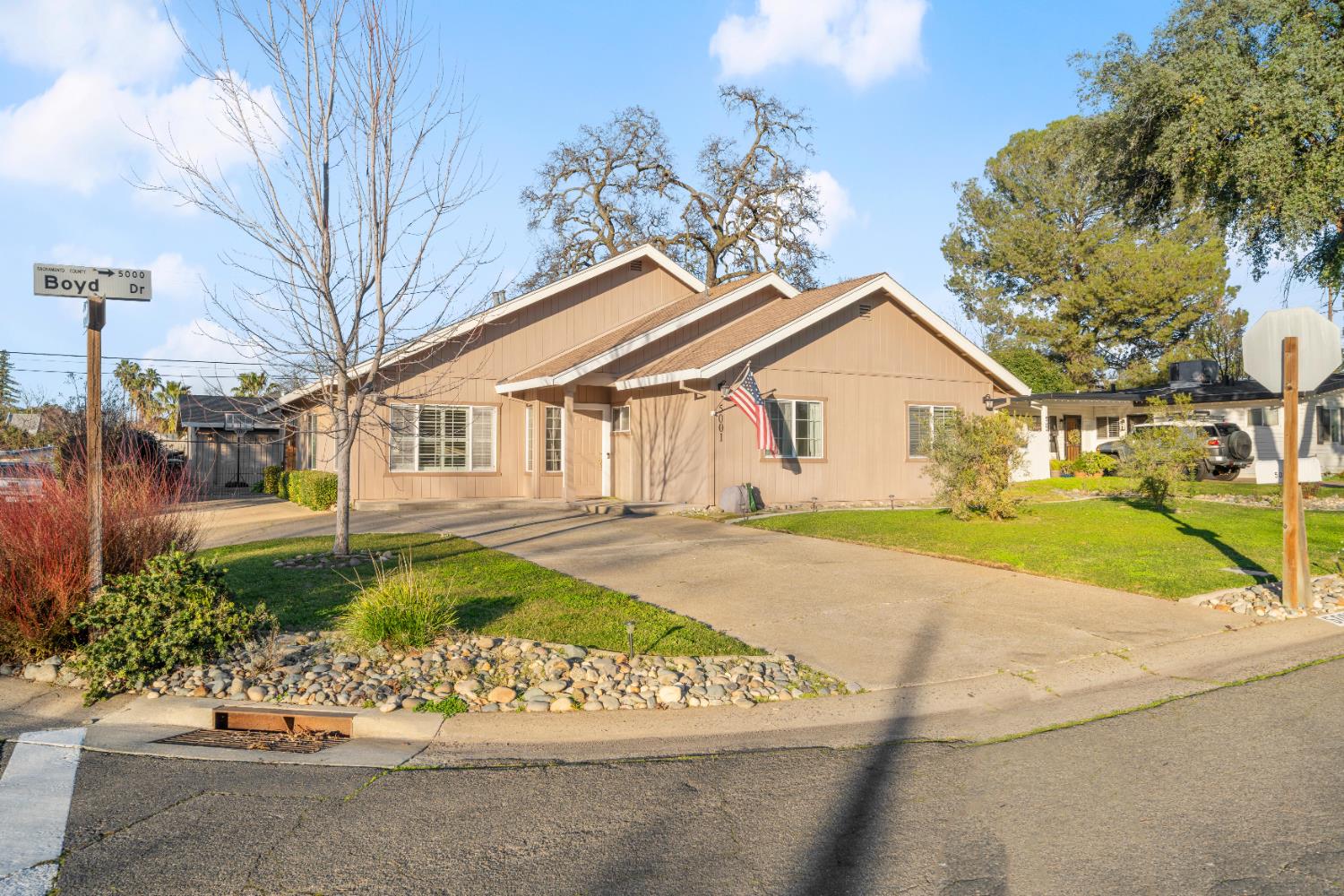 5001 Boyd Drive Carmichael, CA 95608 - Photo 45 of 49 a view of a white house with a yard and garden