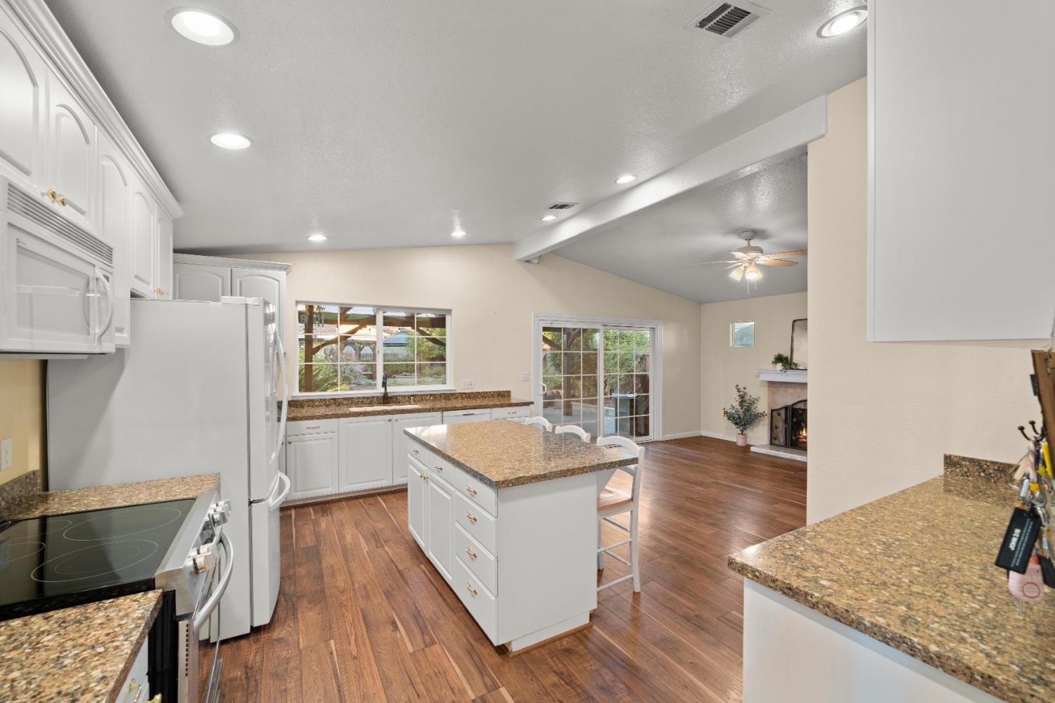 5001 Boyd Drive Carmichael, CA 95608 - Photo 5 of 49 a large kitchen with granite countertop a lot of counter space and wooden floor