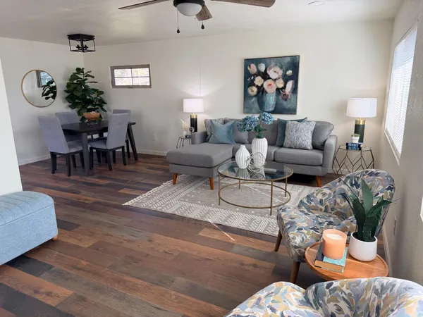 a living room with furniture and wooden floor