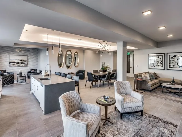 a large kitchen with a table chairs refrigerator and cabinets