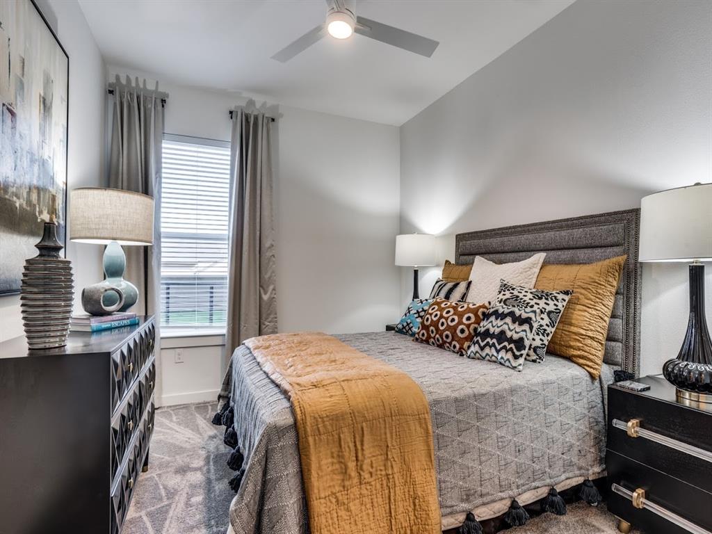 7450 Coronado Avenue, Unit 301 Dallas, TX 75214 - Photo 14 of 23 a bedroom with a bed a mirror and furniture