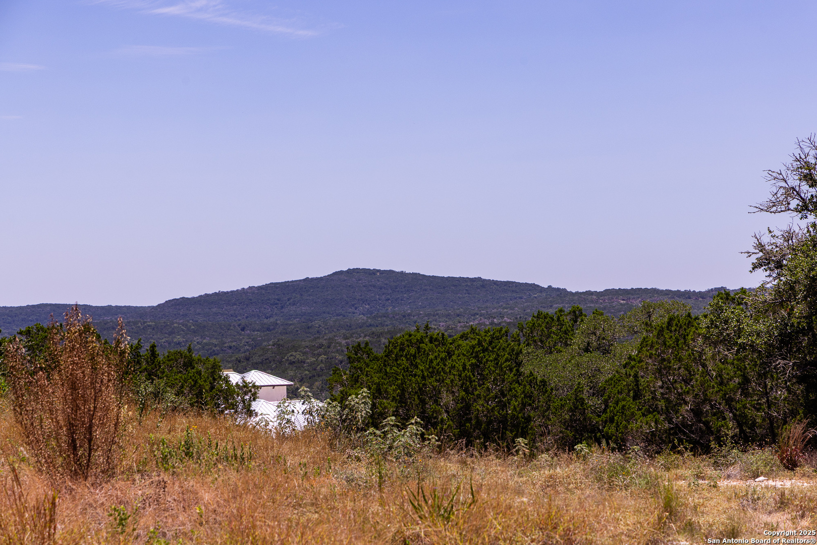 Tbd Pr 177 Helotes, TX 78023 - Photo 11 of 34 a view of a lush green field with mountains in the background