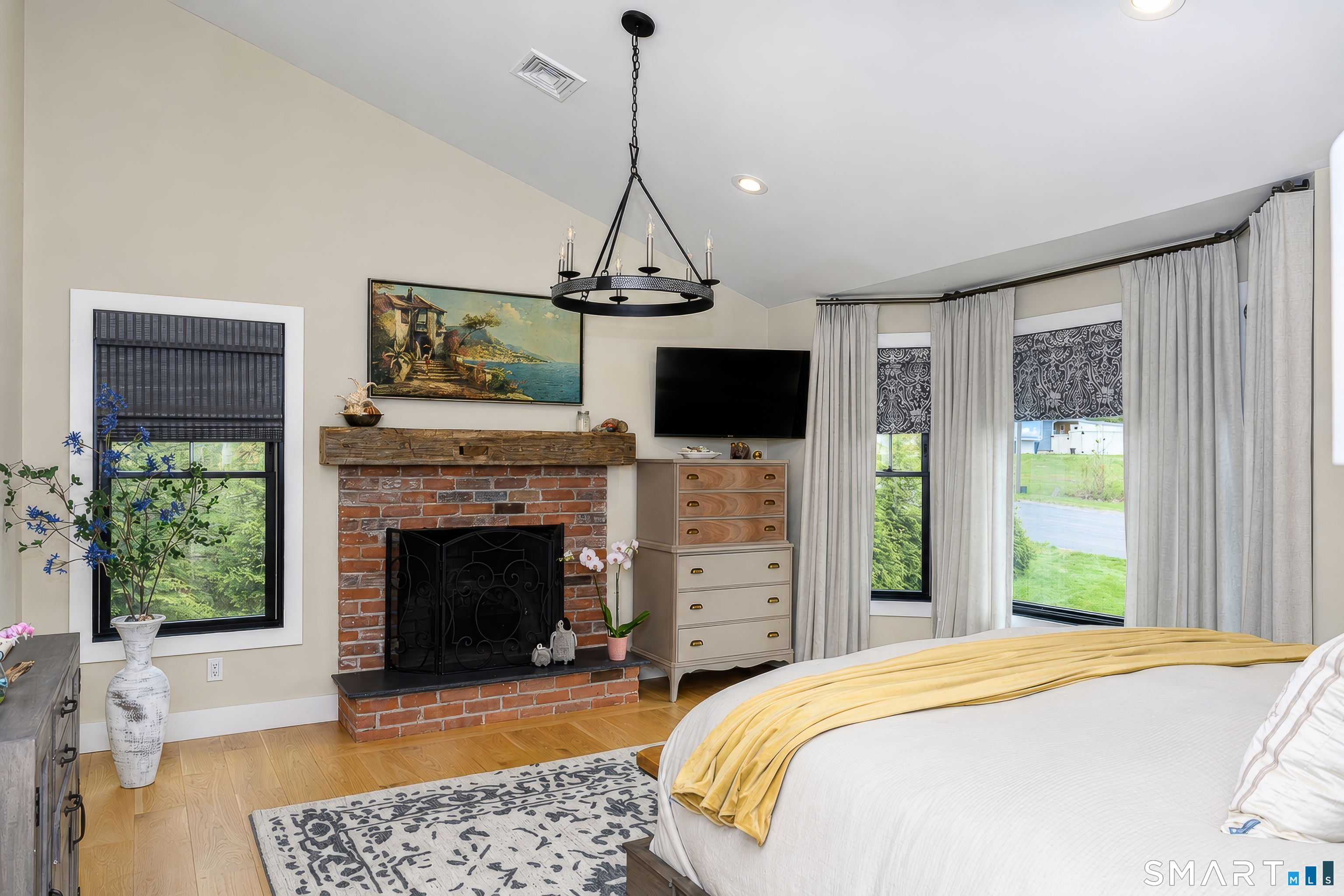 8 East Wharf Road Waterford, CT 06385 - Photo 14 of 40 a bedroom with a bed and a fireplace