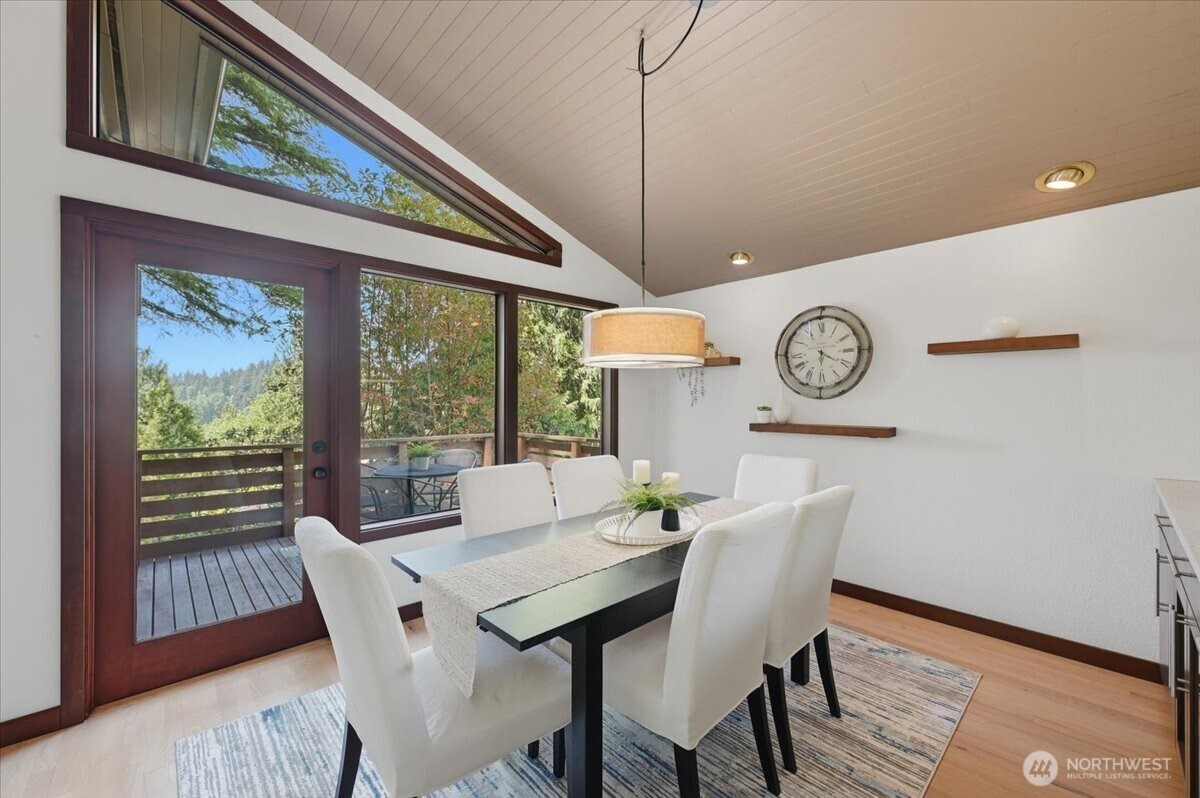 9418 Odin Way Bothell, WA 98011 - Photo 11 of 39 a view of a dining room with furniture window and wooden floor