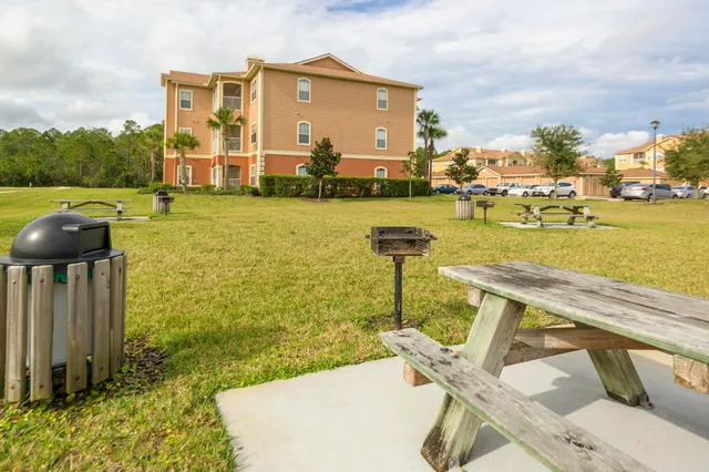 a view of a patio with chairs and potted plants