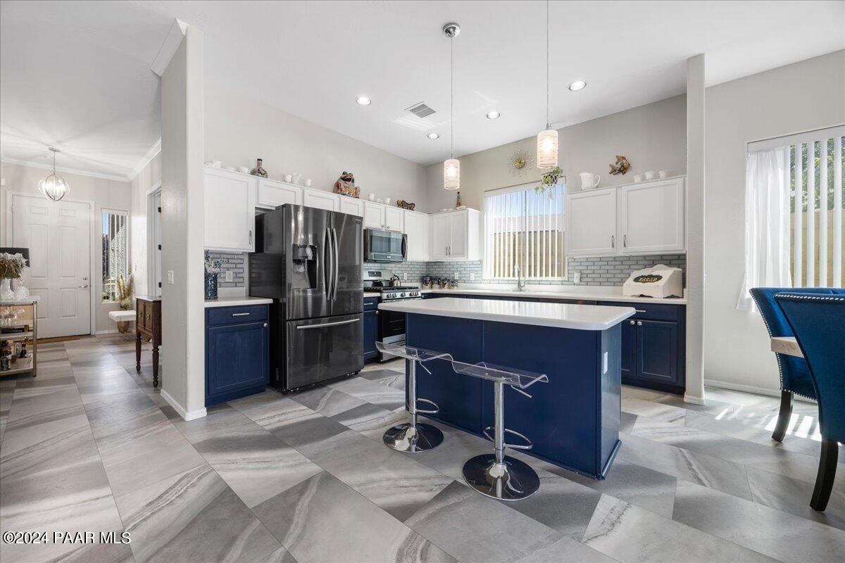 4798 Edgemont Road Prescott Valley, AZ 86314 - Photo 5 of 22 a kitchen with stainless steel appliances kitchen island granite countertop a refrigerator and a stove top oven