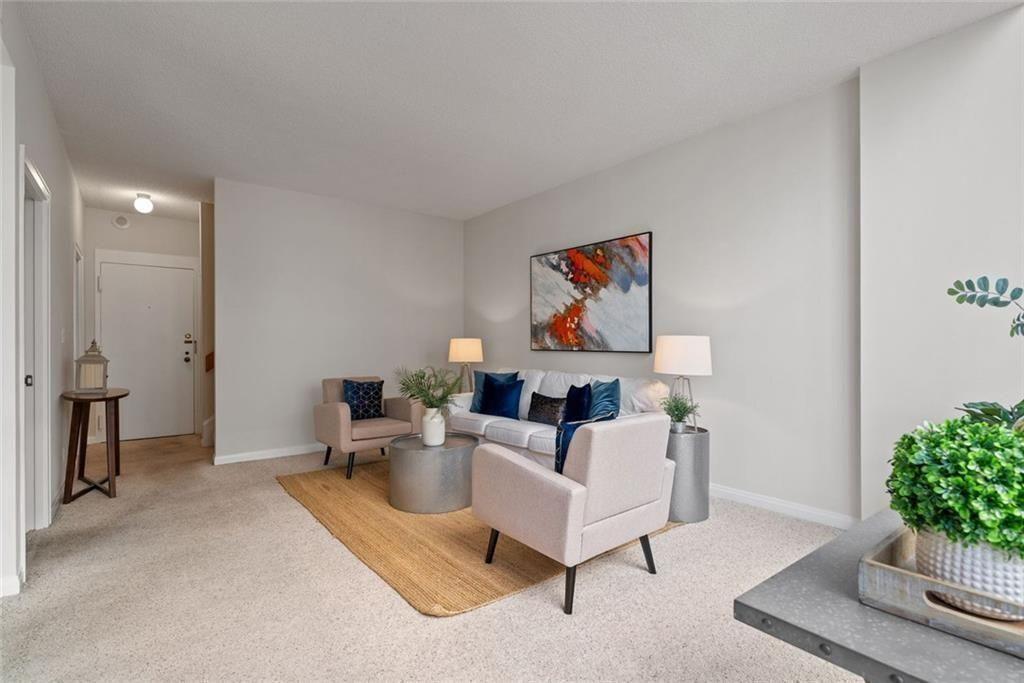 145 15th Street Northeast, Unit 602 Atlanta, GA 30361 - Photo 12 of 43 a living room with furniture and a potted plant