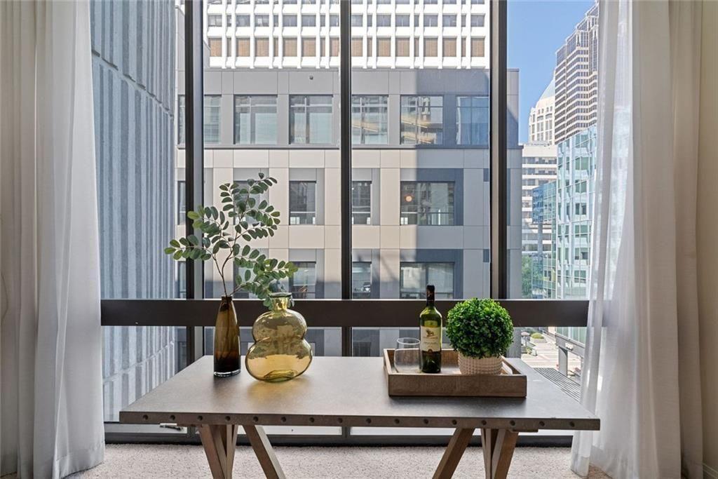 145 15th Street Northeast, Unit 602 Atlanta, GA 30361 - Photo 13 of 43 a table and chairs in front of a window